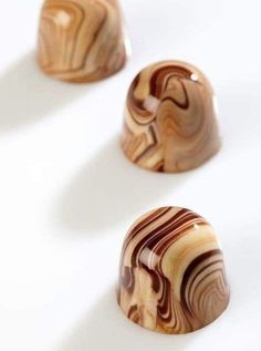 three wooden knobs sitting on top of a white surface