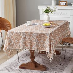 a dining room table with a bowl of fruit on it