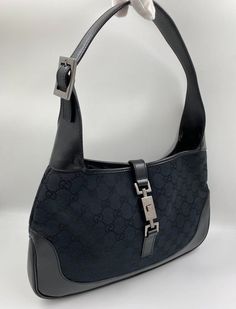 A stunning vintage Gucci Jackie bag made from black canvas with black leather trim and silver hardware. This bag also has the iconic Gucci pin lock closure. Inside the bag is lined with the black Gucci nylon lining and there is a zipped pocket for valuables. This bag is in exceptional vintage condition, a true collectors item and comes with its original Gucci dust bag. Vintage Gucci Jackie, Pin Lock, Vuitton Bag, Diaper Backpack, Black Canvas, Casual Backpack, Baby Bag, Kids Bags, Handbag Backpack