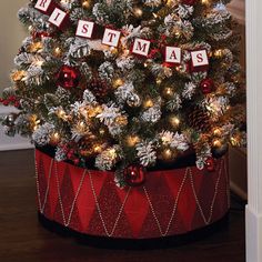 a decorated christmas tree in a red basket