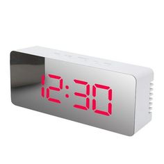 an alarm clock with red numbers on the face is shown in front of a white background