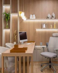 an office with a desk, chair and computer monitor on top of the desk in front of shelves