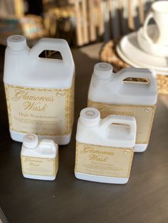 three gallon jugs of liquid sitting on top of a table