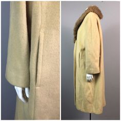 Vintage NOS Deadstock 1960's Beige Wool Long Coat With Mink Fur Collar / Women's XL / 60's Bombshell Rockabilly Swing CoatFeatures:• Beige wool Coat.• Mink fur collar.• 2 oversized buttons at front.• Slightly cropped sleeve length.• 2 waist pockets. • Material: wool with mink collar. • Lined in rayon/acetate. • Circa 1950's or 1960's.Measurements:• Taken laying flat and doubled where necessary • Best fit women's XLBust- up to 42"Waist- 38"Hips- 46"Length- 39 1/2Arm Length- 21 1/4" slightly croppedShoulders- 17"Label: Crestmoor Condition: Great vintage condition with the original 1960's store tags still attached. 60s Bombshell, Beige Wool Coat, Coat With Fur Collar, Wool Long Coat, Coat With Fur, Long Wool Coat, Mink Fur, Cashmere Coat, Fur Collars