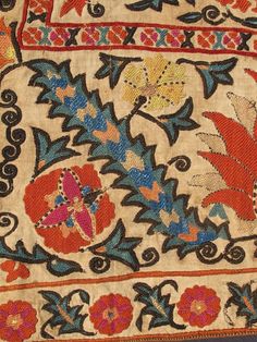 an old rug with flowers and leaves on it