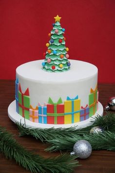 a decorated christmas cake sitting on top of a wooden table