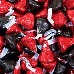 a pile of red and black heart shaped candies