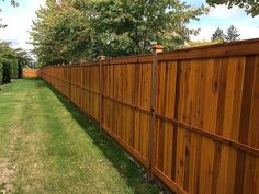 a wooden fence in the middle of a yard