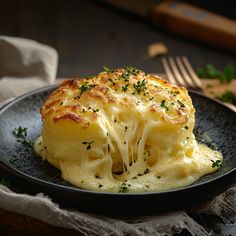 a close up of a plate of food with broccoli and cheese on it