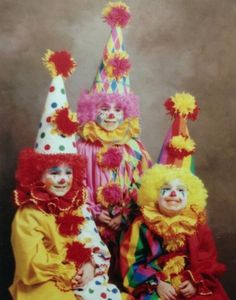 three clowns are posing for a photo