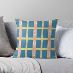 a blue and yellow pillow sitting on top of a couch