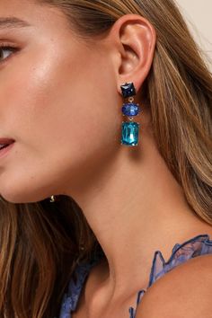 Enhance your aura with the help of radiant accessories like the Petit Moments Vibrant Persona Blue Rhinestone Statement Drop Earrings! Shiny, gold-toned metal shapes the settings for these gorgeous earrings, which showcase a series of geometric rhinestone gems in varying hues of blue and fall in a drop-style silhouette. Post backs. 2" long. Man Made Materials. Imported. Lulus | Vibrant Persona Blue Rhinestone Statement Drop Earrings. Lulu Fashion, Hues Of Blue, Deep Winter, Statement Drop Earrings, Accessories Jewelry Earrings, Blue Rhinestones, Vibrant Blue, Gorgeous Earrings, Gold Tone Metal