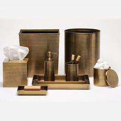 gold bathroom accessories including toiletries, tissue and soap dispenser