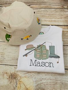 "Fishing shirt and hat make a perfect addition to any little fisherman's wardrobe. The shirt can be long or short sleeve and is embroidered with a fishing trio design and monogram below. Monogram can be omitted if desired. Optional hat is embroidered with 6 designs of lures, hooks and fish. Hat is bucket style, 100% cotton: fits sizes 4-6yrs: 20 1/2\"~20 7/8\", 6 1/2~6 5/8 OR 7-10yrs: 21 1/4\"~21 5/8\", 6 3/4~6 7/8. All items from this shop begin as blank items purchased from sourced vendors and Little Boy Fishing Shirt, Monogram Fishing Shirt, Fishing Monogram, Embroidered Baby Clothes, Fishing Outfit, Fish Hat, Kids Sewing, Boy Fishing, Baby Monogram