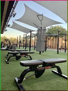 an outdoor gym with benches and equipment