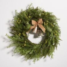 a christmas wreath with two bells hanging from it