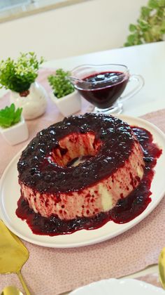 a cake on a plate with blueberry sauce