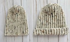 two knitted beanies sitting next to each other on top of a wooden floor