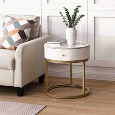 a living room with a chair, table and potted plant on the end table