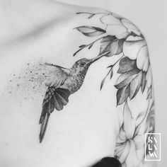 a black and white photo of a hummingbird on the shoulder