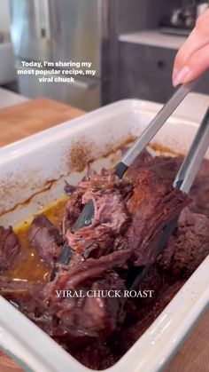 a person is cutting up some meat in a pan