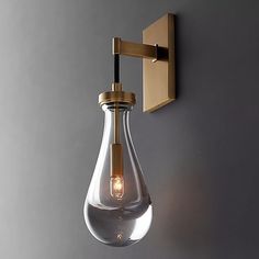 a light that is on the wall next to a gray wall with a white background