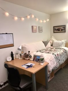 a bed room with a neatly made bed and desk