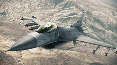 an air force jet flying through the sky over a mountain range with mountains in the background