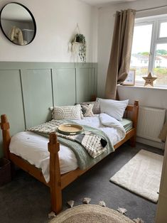 a bed sitting in a bedroom next to a window