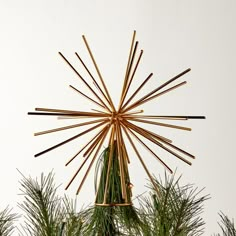 a star ornament made out of sticks and pine needles