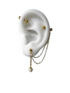 a white and gold ear with chains attached to it