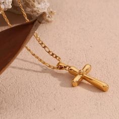 Indulge in luxury with the Delaney Cross Necklace. Made with exquisite craftsmanship, this stunning piece will add a touch of elegance to any outfit. The delicate cross design symbolizes strength and grace, making it the perfect accessory for any fashion-forward individual looking to make a statement. Elevate your style and make a lasting impression with this beautiful necklace. Item Details: 18Kt Gold Plated Stainless Steel Water Resistant Tarnish Resistant Hypoallergenic Color: Coloration in t Cross Design, Cross Designs, Gold Collection, Beautiful Necklace, Steel Water, Ring Bracelet, Beautiful Necklaces, Cross Necklace, Fashion Forward