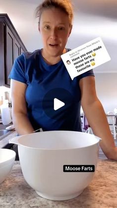 a woman standing in front of a large bowl