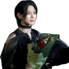 a young man holding a bouquet of flowers