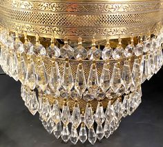 a gold chandelier with clear crystal drops hanging from it's centerpiece