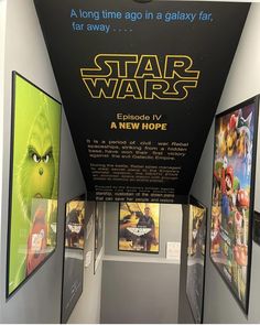 star wars movie posters are on display in a museum exhibit area with an advertisement for the film