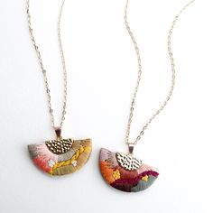 two necklaces that have different designs on them