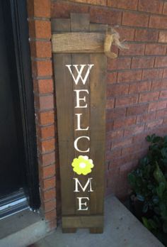 a welcome sign on the side of a brick building