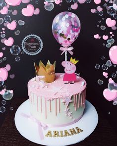 a birthday cake with peppa the pig on top and balloons in the shape of hearts