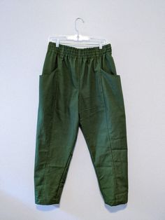 a pair of green pants hanging on a hanger