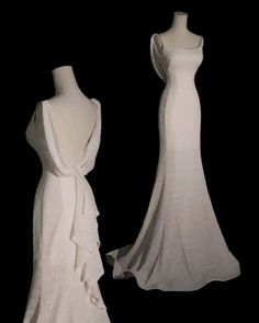 two white dresses on mannequins with black background