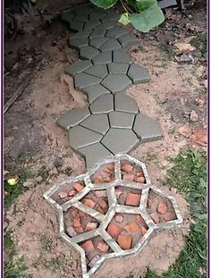 a garden path made out of cement blocks