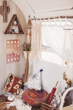 a room filled with lots of different types of pillows and blankets on top of a wooden table