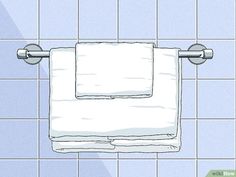 a white towel is hanging on the wall in a bathroom with blue tiled walls and tile flooring