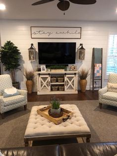 a living room filled with furniture and a flat screen tv mounted on the wall over a fireplace