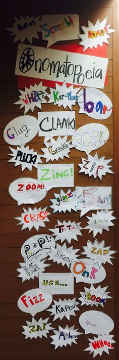 a bulletin board that has many different types of speech bubbles attached to it with writing on them