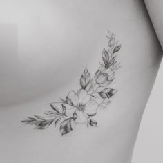 a woman's stomach with flowers and leaves on it