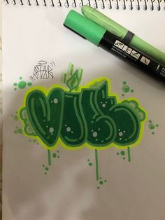 a green marker pen sitting on top of a paper with the word jesus written in it