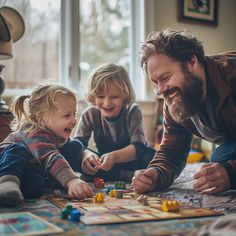 a man playing with two children on the floor