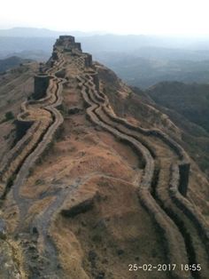 an aerial view of the great wall of china, built on top of a mountain